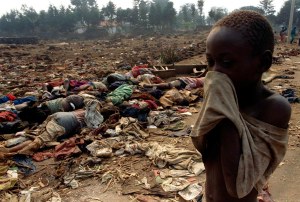 A Rwandan boy covers his face from the horrific stench of dead bodies, victims of the Rwandan Genocide. Credit: Reuters.