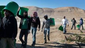 Thousands of Palestinians work for Israeli owned farms, and tens of thousands more in Israeli factories - at up to 5 times the average Palestinian wage. (Credit: Outside industrial parks in the West Bank, thousands of Palestinians work for Israeli-owned farms. (Credit: Rina Castelnuovo/The New York Times)