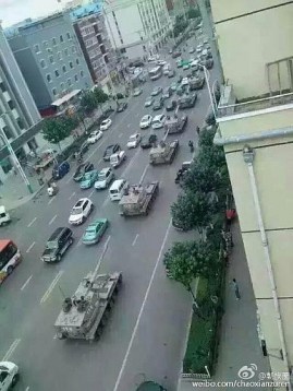 Chinese tanks roll through the streets of Yanji in Jilin province, toward the nearby China-Korea border on August 22
