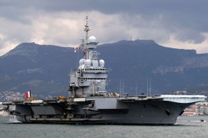 FILE - In this March 20, 2011 file photo, France's nuclear-powered aircraft carrier Charles de Gaulle leaves its home port of Toulon, southern France. France has decided to deploy an aircraft carrier in the Persian Gulf to help fighting Islamic State group in Iraq and Syria. The French president Francois Hollande announced Thursday Nov.5, 2015 his decision at the inauguration of the country’s new ultra-secured defense ministry in Paris. (AP Photo/Claude Paris, File)