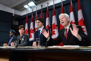 Minister of Foreign Affairs Stephane Dion delivers a statement as he is joined by Prime Minister Justin Trudeau, right to left, Minister of International Development and La Francophonie Marie-Claude Bibeau and Minister of National Defence Harjit Sajjan during a press conference at the National Press Theatre in Ottawa on Feb. 8, 2016. (Credit: The Canadian Press/Sean Kilpatrick)
