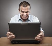 angry-man-clenching-teeth-at-computer